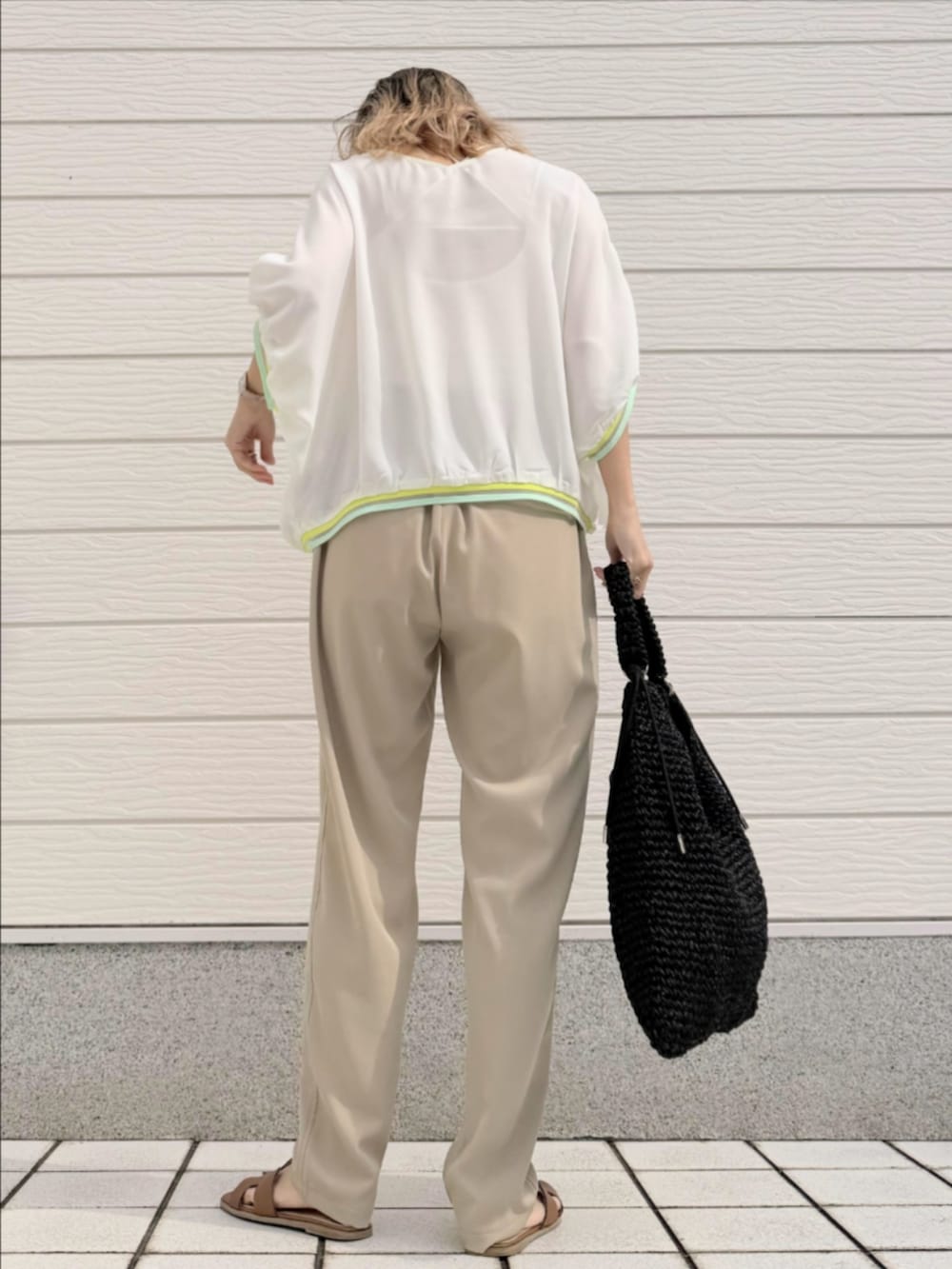 ブラック系のトートバッグ、ベージュ系のその他パンツ、ホワイト系のシャツ/ブラウスを着用したレディースの冬コーディネートの3枚目の写真