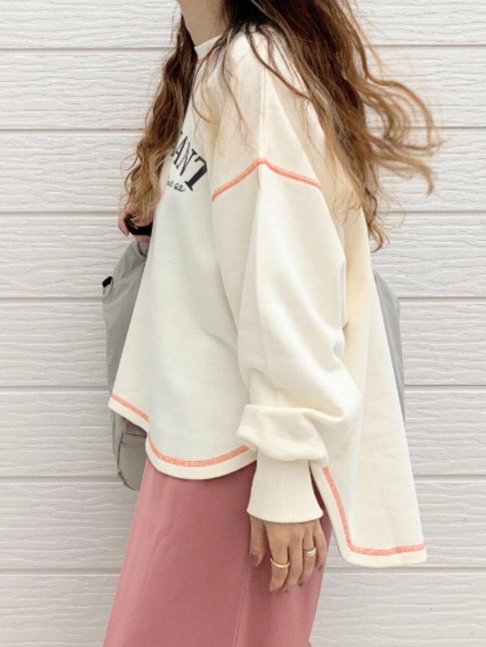 ホワイト系のスニーカー、グレー系のボストンバッグ、ホワイト系のスウェットを着用したレディースの秋コーディネートの4枚目の写真