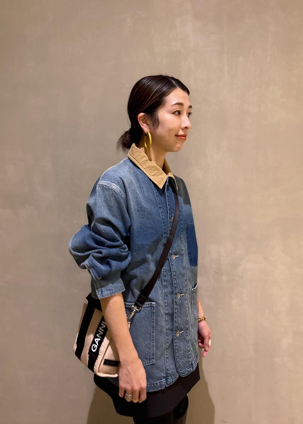 ベージュ系のトートバッグ、ブラック系のブーツ、ブラック系のスカートを着用したレディースの冬コーディネートの9枚目の写真