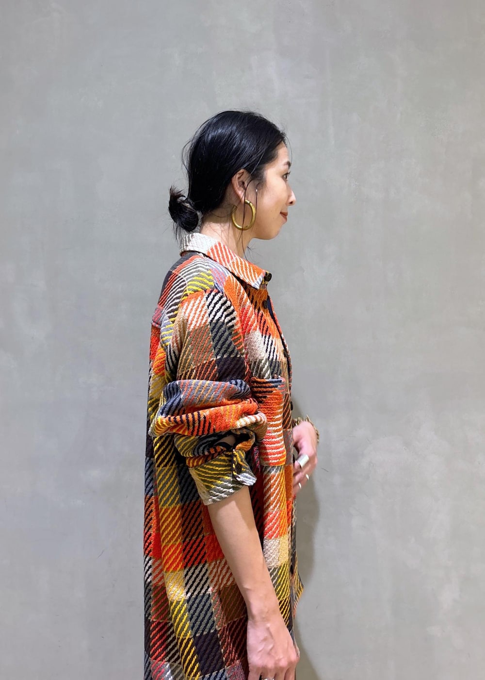 ブラック系のハンドバッグ、グリーン系のスラックスを着用したレディースの秋コーディネートの7枚目の写真