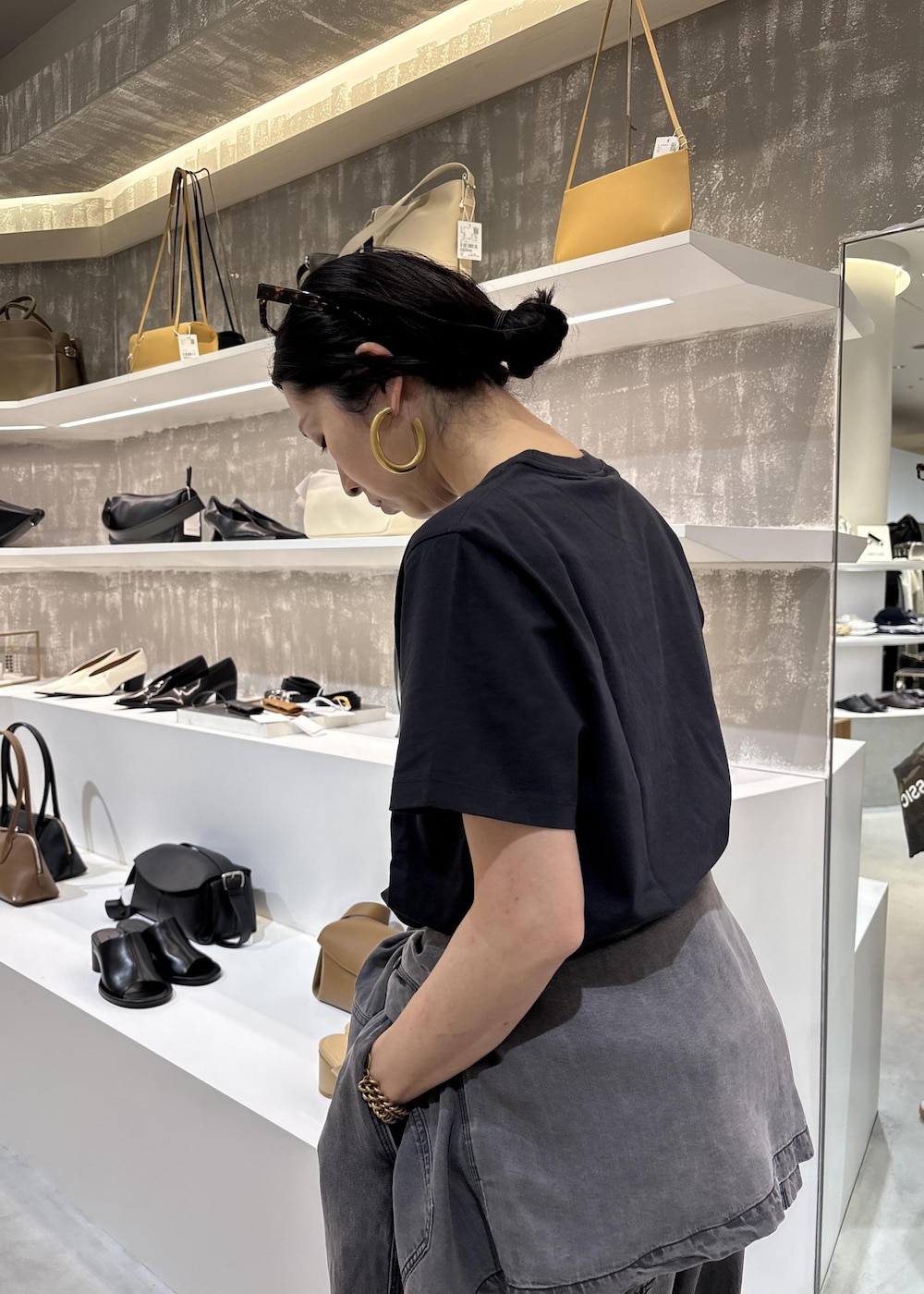 ブラック系のシャツ/ブラウス、ブラック系のデニムパンツ、グレー系のTシャツ/カットソーを着用したレディースの春コーディネートの10枚目の写真