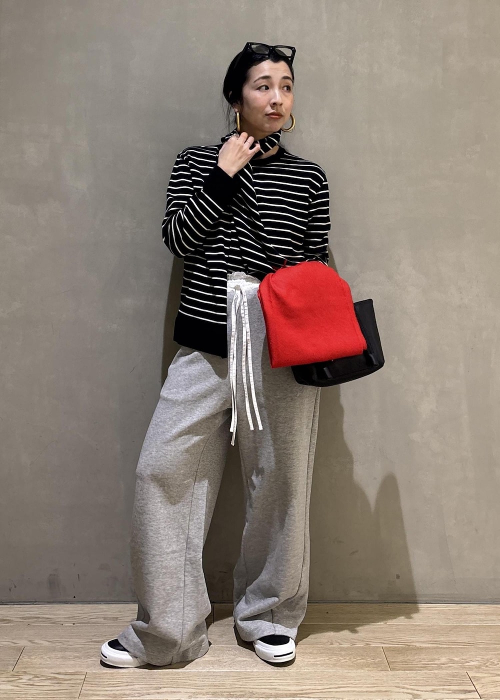 グレー系のその他パンツ、レッド系のマフラーを着用したレディースの冬コーディネートの2枚目の写真