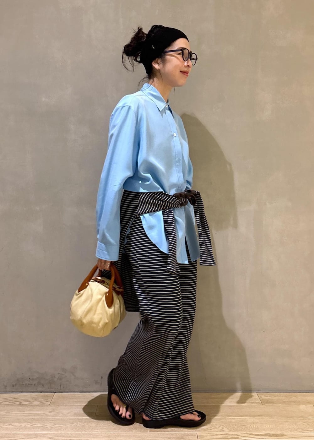 ブルー系のシャツ/ブラウス、ブラック系のサンダルを着用したレディースの夏コーディネートの7枚目の写真