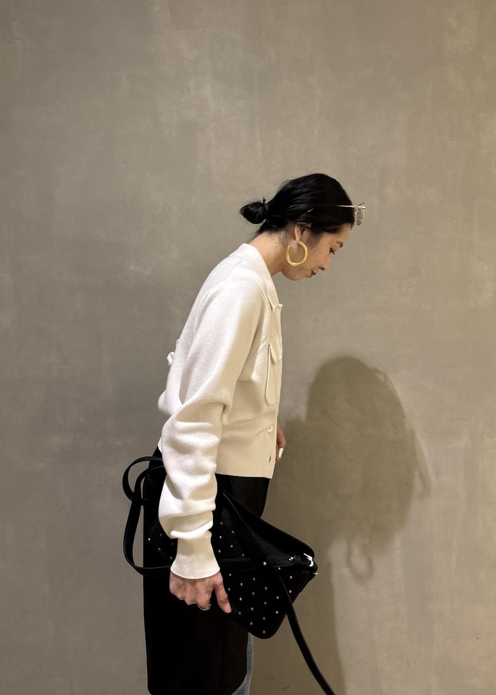 ブラック系のサンダル、ブルー系のデニムパンツ、ブラック系のダウンジャケット/コートを着用したレディースの冬コーディネートの10枚目の写真