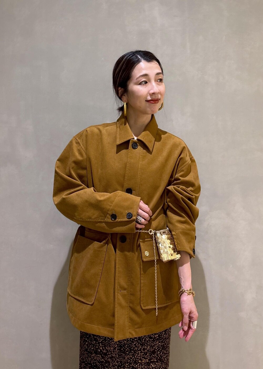 ブラック系のブーツ、ブラック系のスカート、イエロー系のブルゾンを着用したレディースの冬コーディネートの10枚目の写真