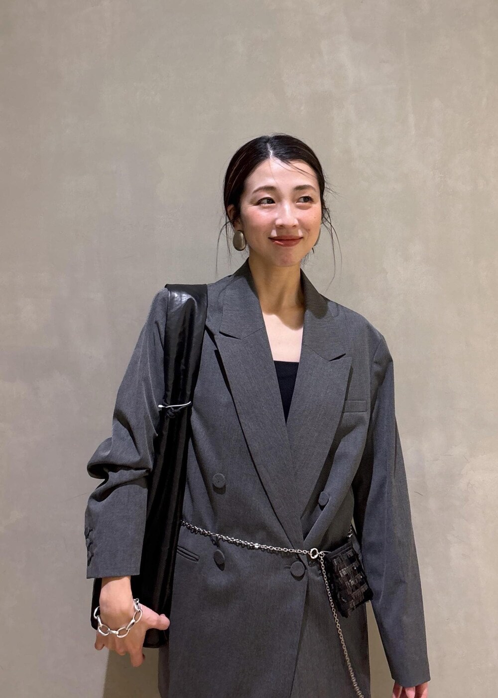 ブラック系のショルダーバッグ、グレー系のその他パンツ、グレー系のテーラードジャケットを着用したレディースの冬コーディネートの10枚目の写真