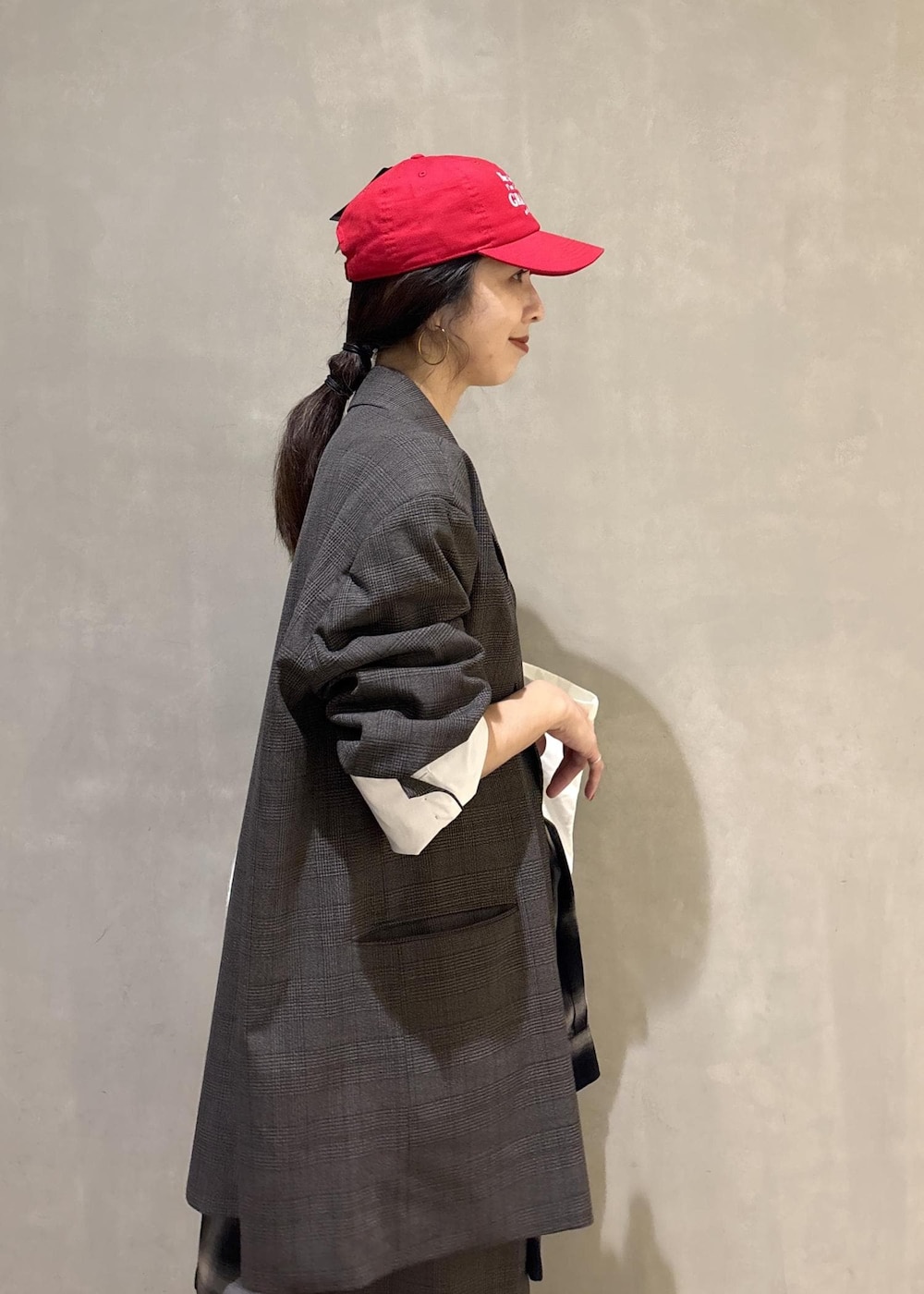 ブラック系のシャツ/ブラウス、グリーン系のトートバッグ、ブラック系のキャップを着用したレディースの秋コーディネートの7枚目の写真