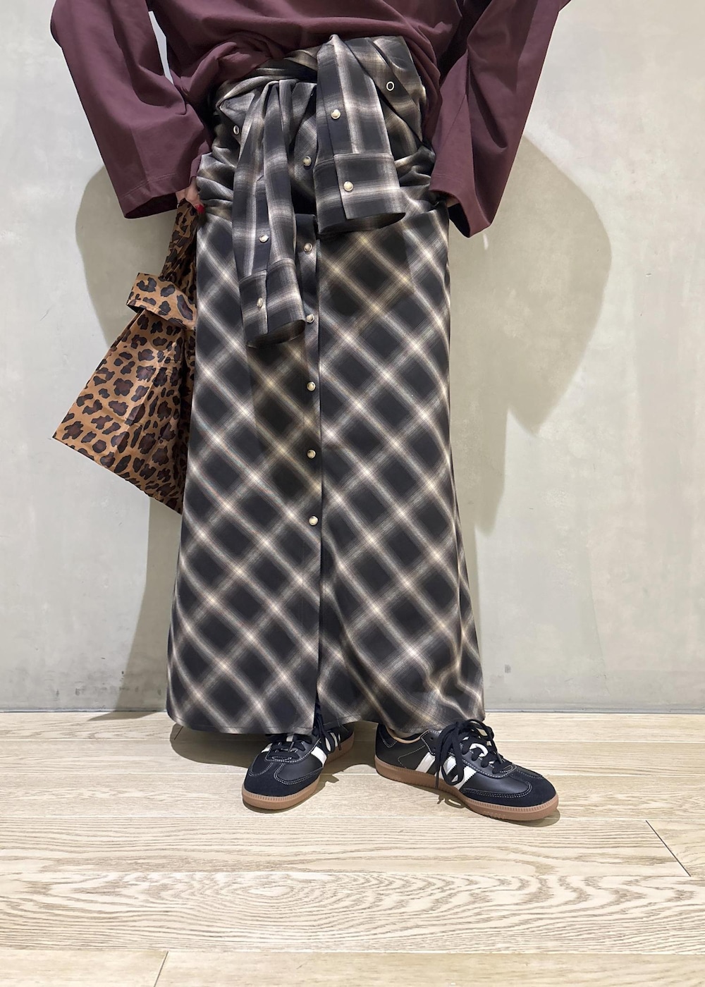 ブラック系のスニーカーを着用したレディースの秋コーディネートの10枚目の写真