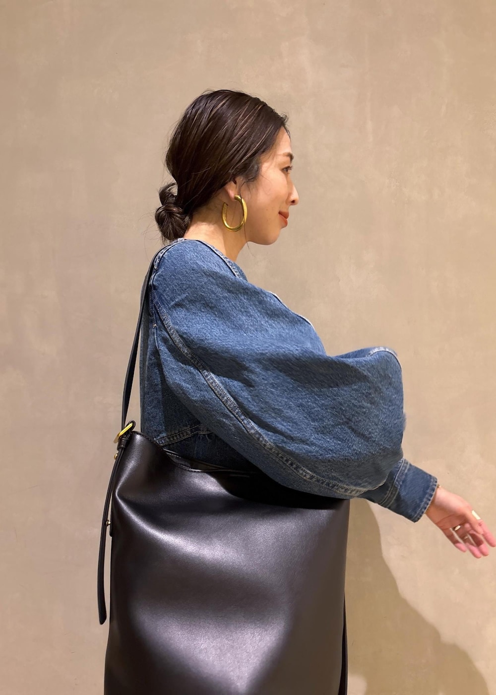 ブルー系のシャツ/ブラウス、ブルー系のデニムパンツ、ブラック系のショルダーバッグを着用したレディースの冬コーディネートの9枚目の写真