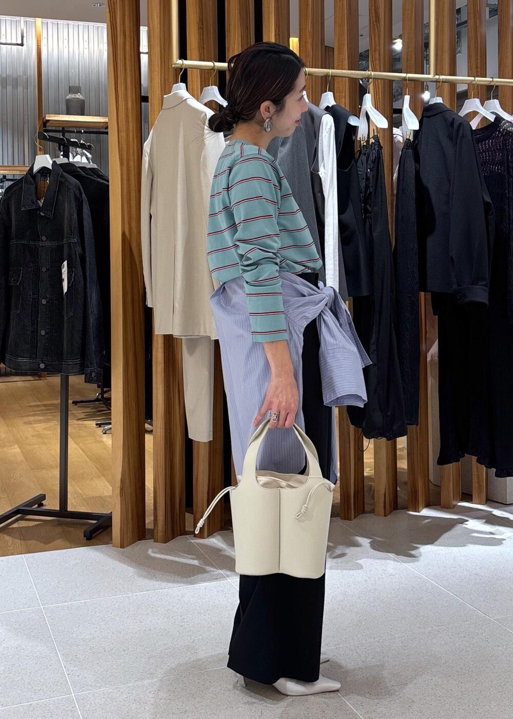 ホワイト系のパンプス、ブルー系のTシャツ/カットソー、ブルー系のシャツ/ブラウスを着用したレディースの冬コーディネートの5枚目の写真