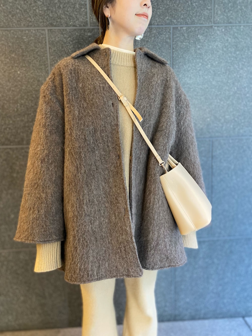 ベージュ系のその他パンツ、ベージュ系のジャケット/アウター、ベージュ系のニット/セーターを着用したレディースの春コーディネートの2枚目の写真