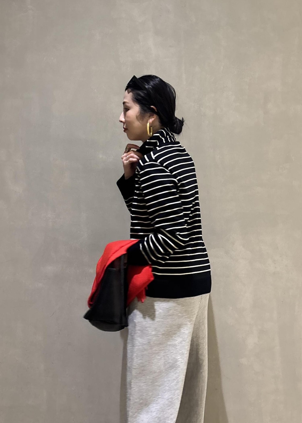 グレー系のその他パンツ、レッド系のマフラーを着用したレディースの冬コーディネートの9枚目の写真