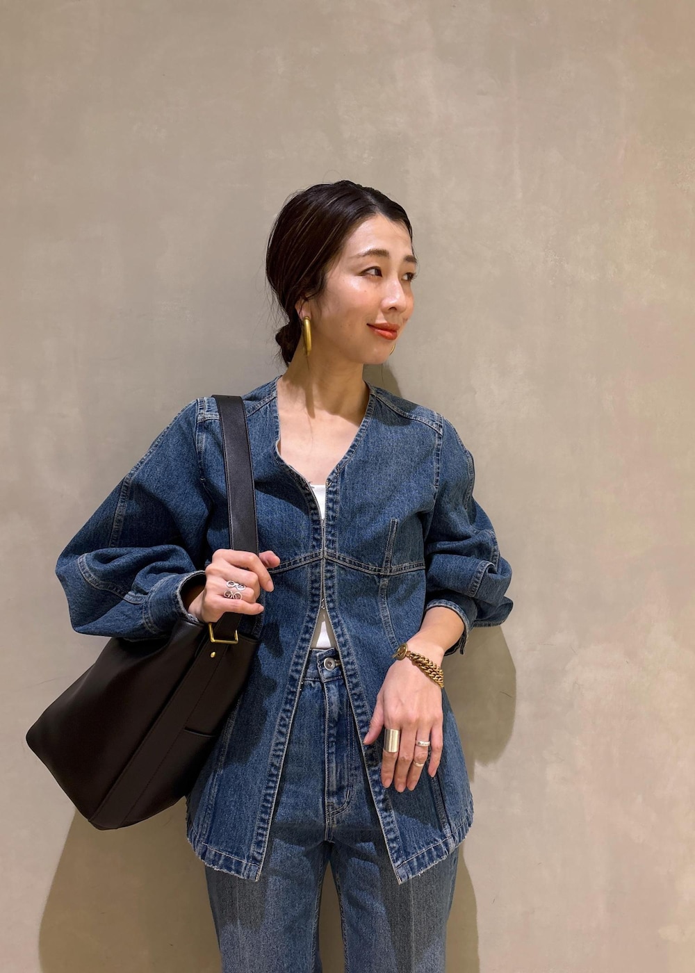 ブルー系のシャツ/ブラウス、ブルー系のデニムパンツ、ブラック系のショルダーバッグを着用したレディースの冬コーディネートの8枚目の写真