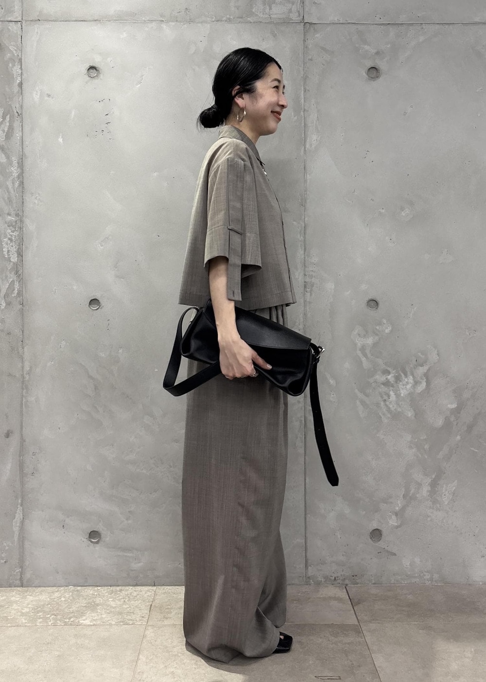 ブラック系のサンダル、ベージュ系のシャツ/ブラウス、ベージュ系のスラックスを着用したレディースの春コーディネートの4枚目の写真