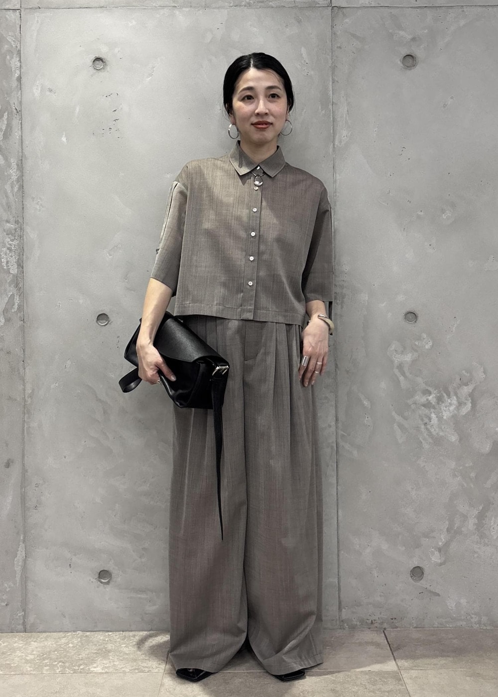 ブラック系のサンダル、ベージュ系のシャツ/ブラウス、ベージュ系のスラックスを着用したレディースの春コーディネートの3枚目の写真