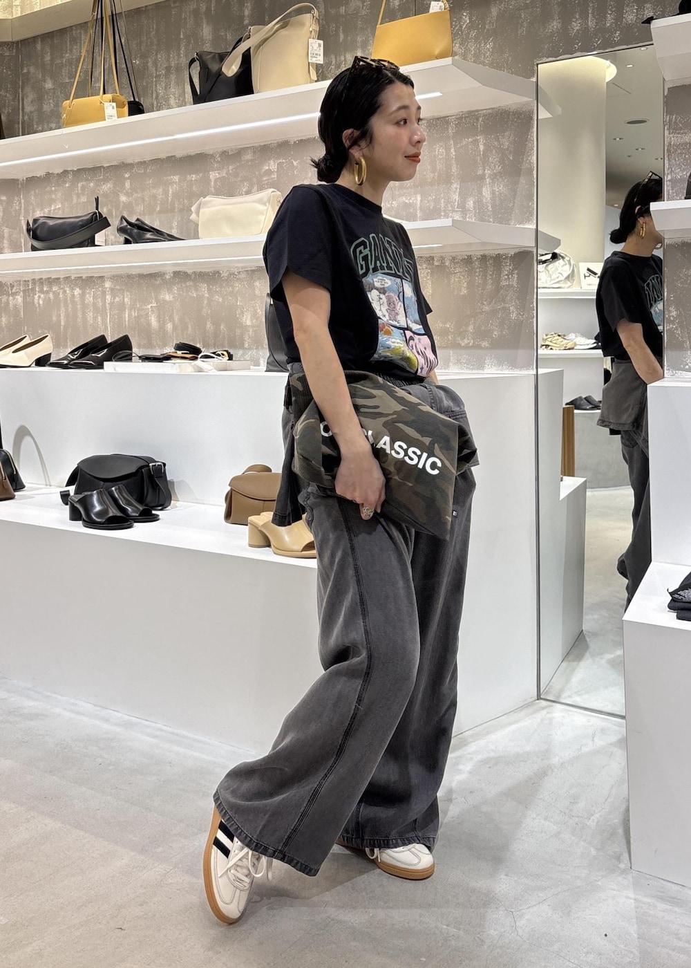 ブラック系のシャツ/ブラウス、ブラック系のデニムパンツ、グレー系のTシャツ/カットソーを着用したレディースの春コーディネートの2枚目の写真