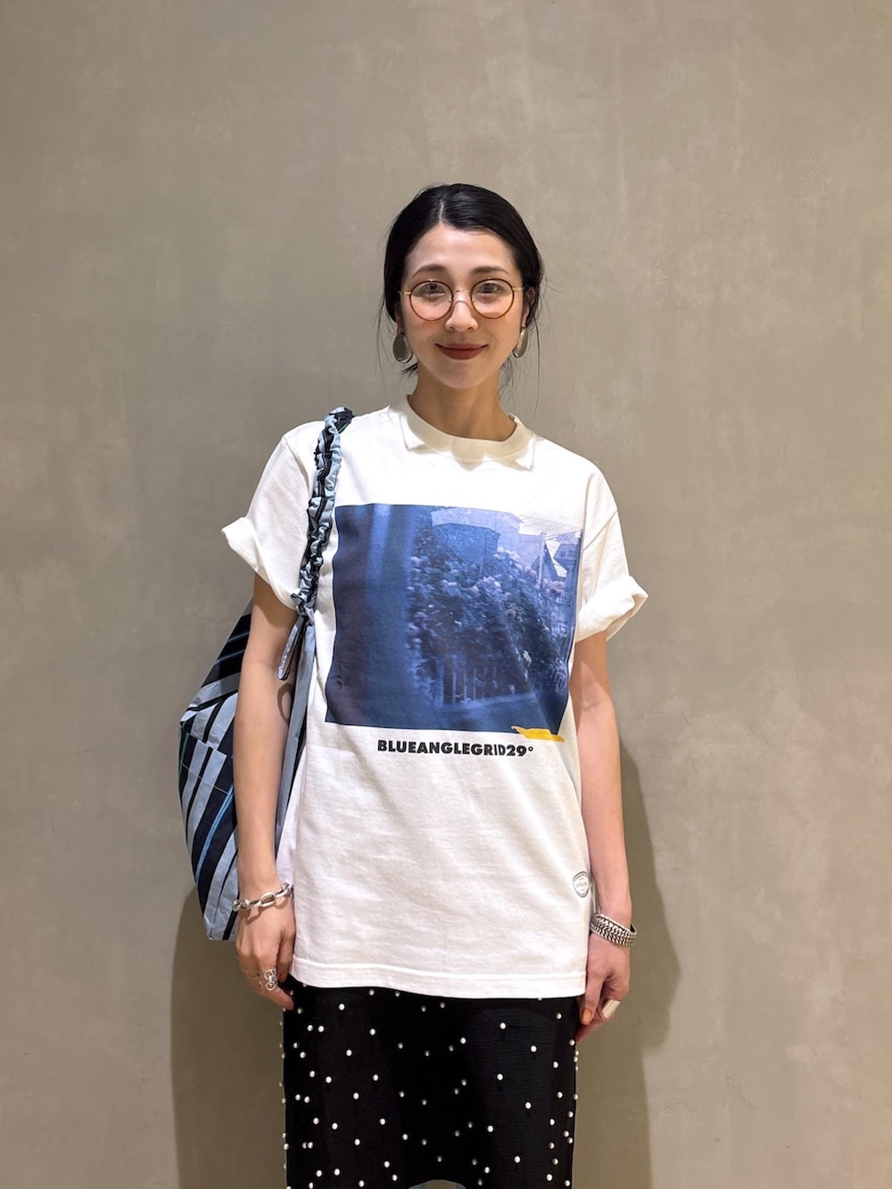 ブルー系のデニムパンツ、ブルー系のショルダーバッグ、ホワイト系のTシャツ/カットソーを着用したレディースの春コーディネートの10枚目の写真