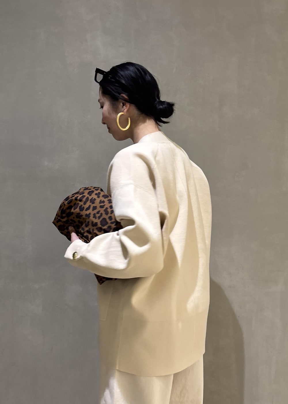 ブラック系のサンダル、ホワイト系のデニムパンツ、ホワイト系のカーディガン/ボレロを着用したレディースの冬コーディネートの9枚目の写真