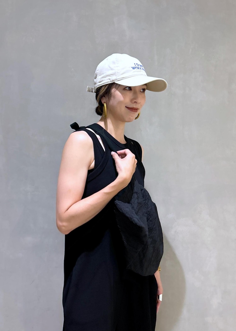 ブラック系のスニーカー、ブラック系のつなぎ/オールインワン、ベージュ系のキャップを着用したレディースの夏コーディネートの9枚目の写真