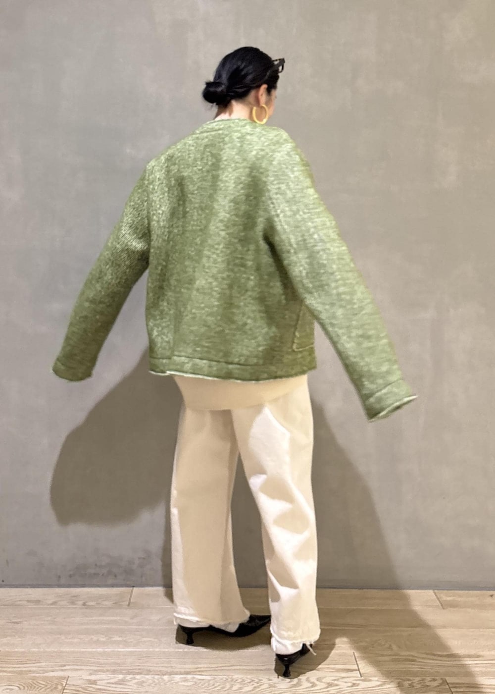 ブラック系のサンダル、ホワイト系のデニムパンツ、ホワイト系のカーディガン/ボレロを着用したレディースの冬コーディネートの4枚目の写真