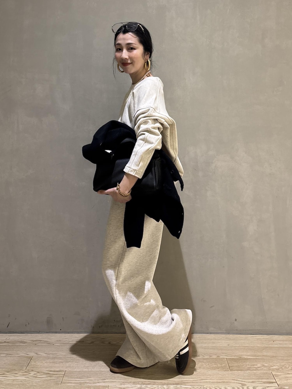 ブラック系のハンドバッグ、ホワイト系のその他パンツ、ホワイト系のスウェットを着用したレディースの冬コーディネートの5枚目の写真