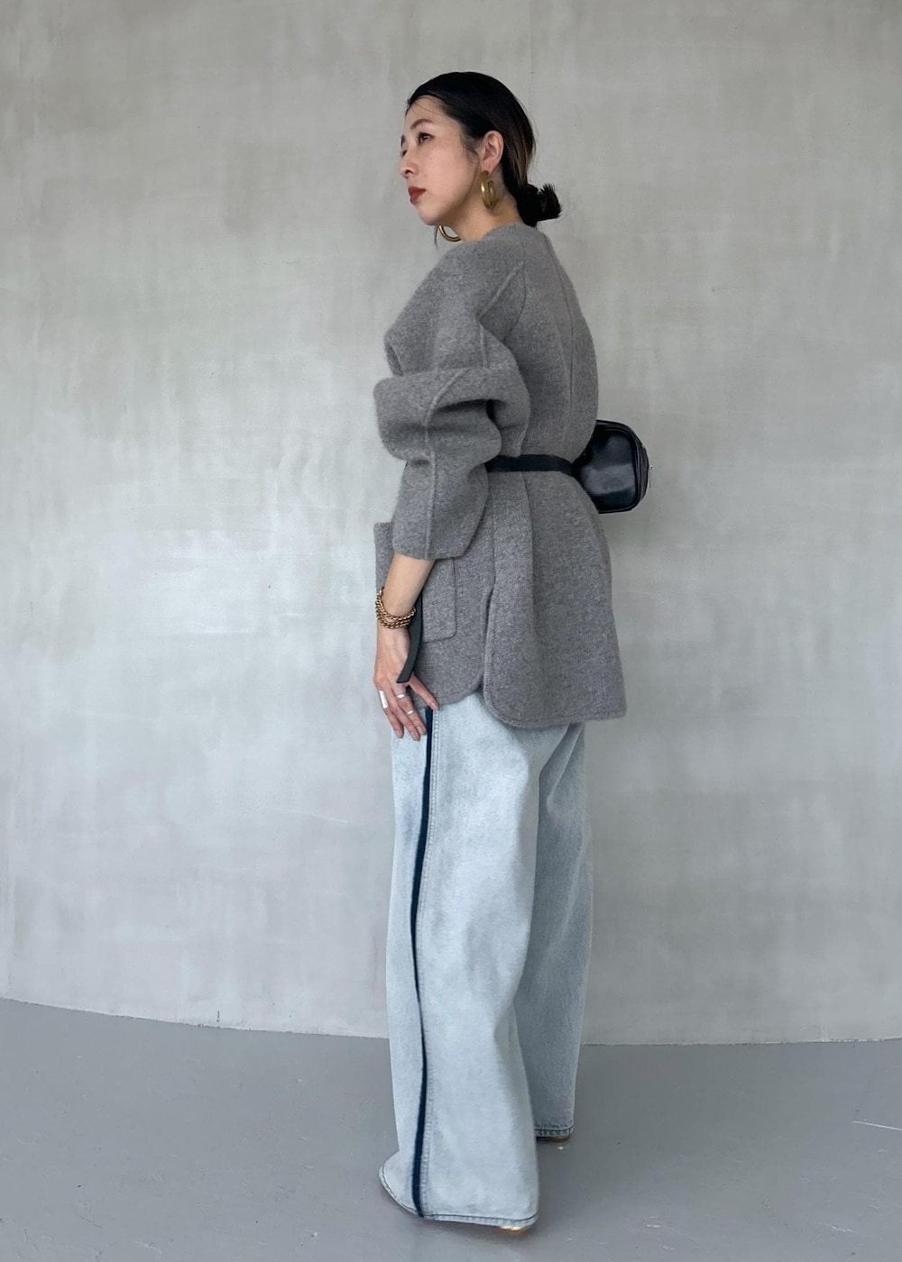 ゴールド系のパンプス、ブルー系のその他パンツ、ブラック系のボストンバッグを着用したレディースの秋コーディネートの7枚目の写真