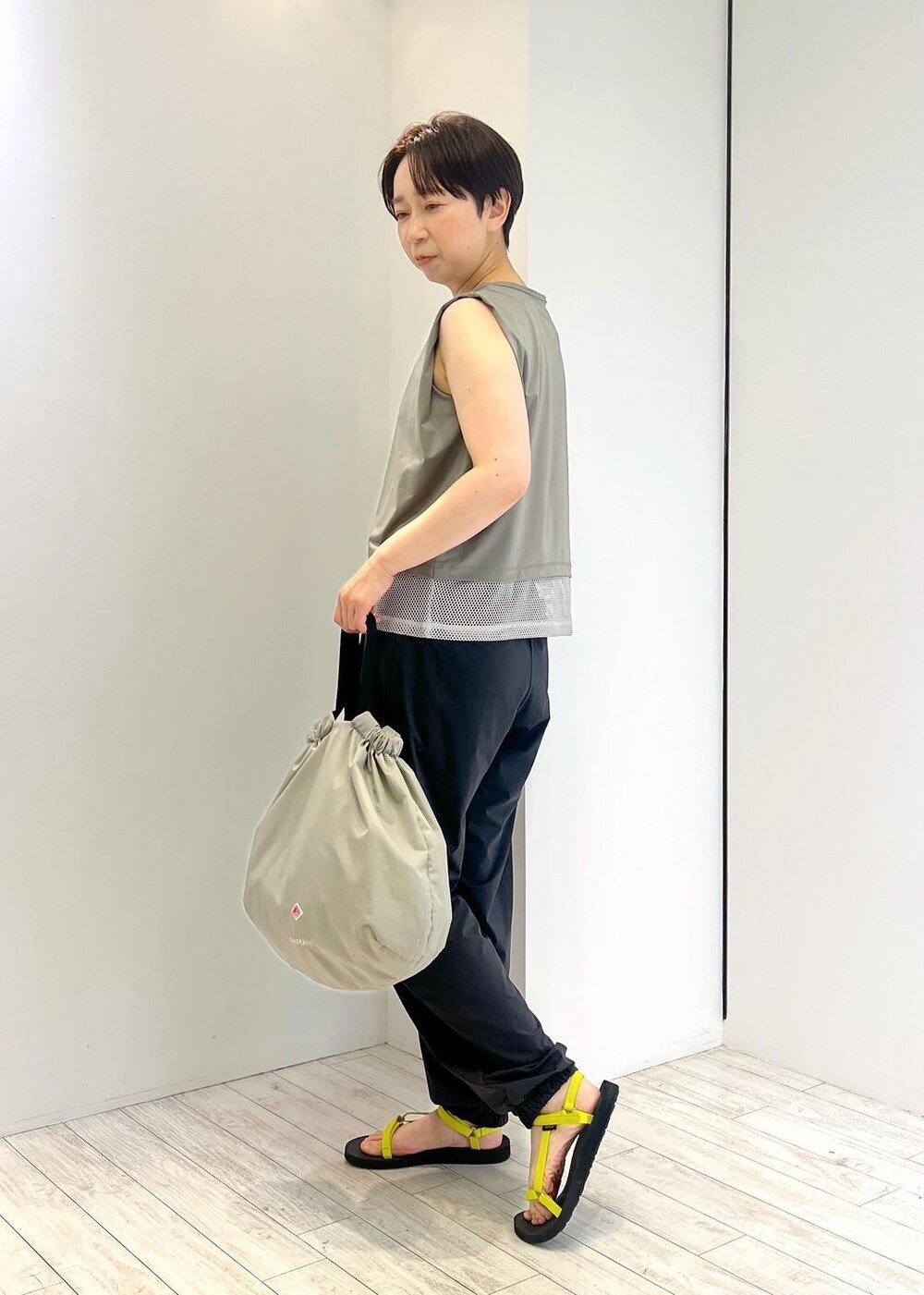 グリーン系のTシャツ/カットソー、ブラック系のカーゴパンツ、ブラック系のサンダルを着用したレディースの夏コーディネートの3枚目の写真