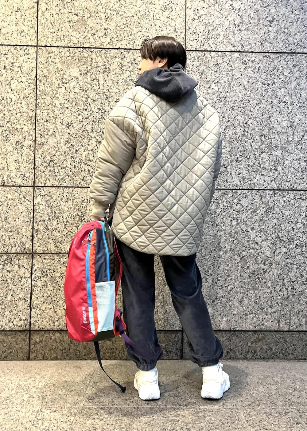 ブラック系のパーカー、ブラック系のその他パンツ、グリーン系のダウンジャケット/コートを着用したレディースの冬コーディネートの3枚目の写真