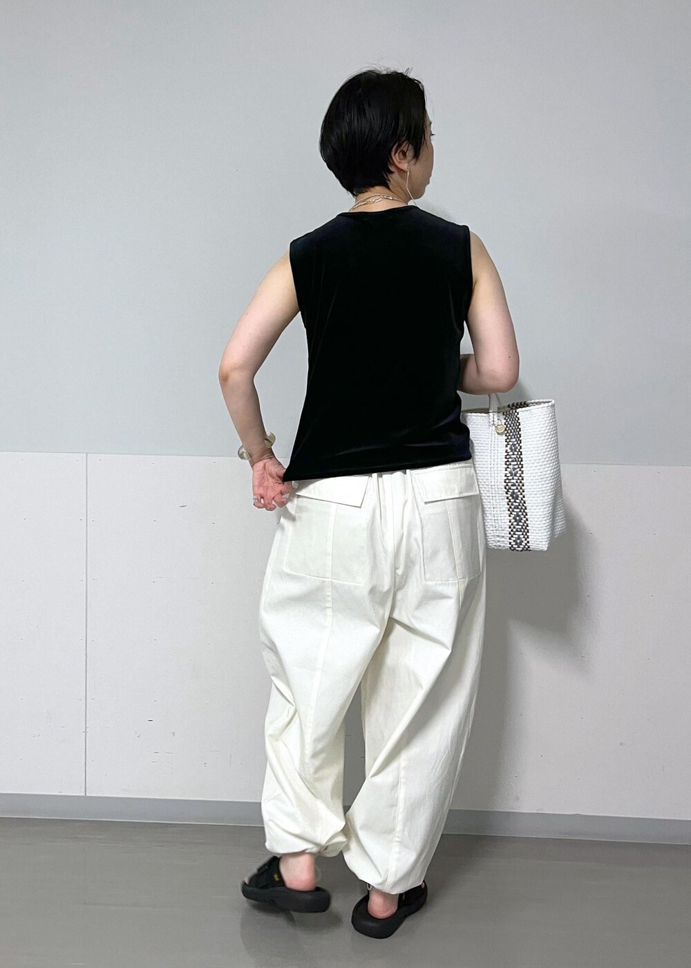 ホワイト系のカーゴパンツ、ベージュ系のショルダーバッグ、ベージュ系のカーディガン/ボレロを着用したレディースの夏コーディネートの4枚目の写真