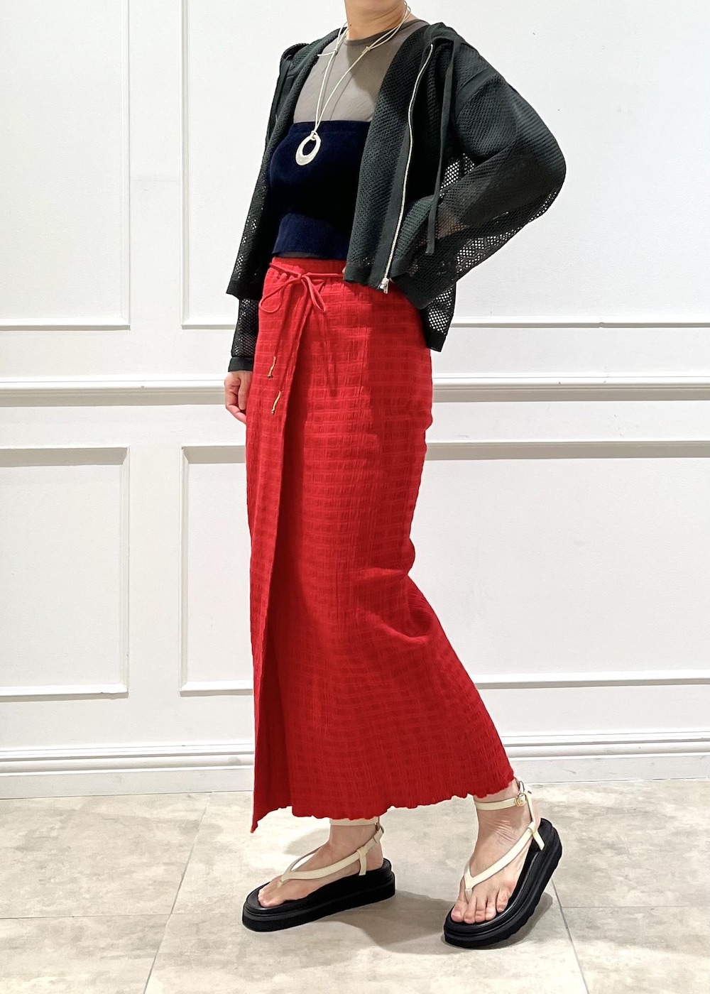 ホワイト系のサンダル、レッド系のスカート、グリーン系のTシャツ/カットソーを着用したレディースの春コーディネートの2枚目の写真