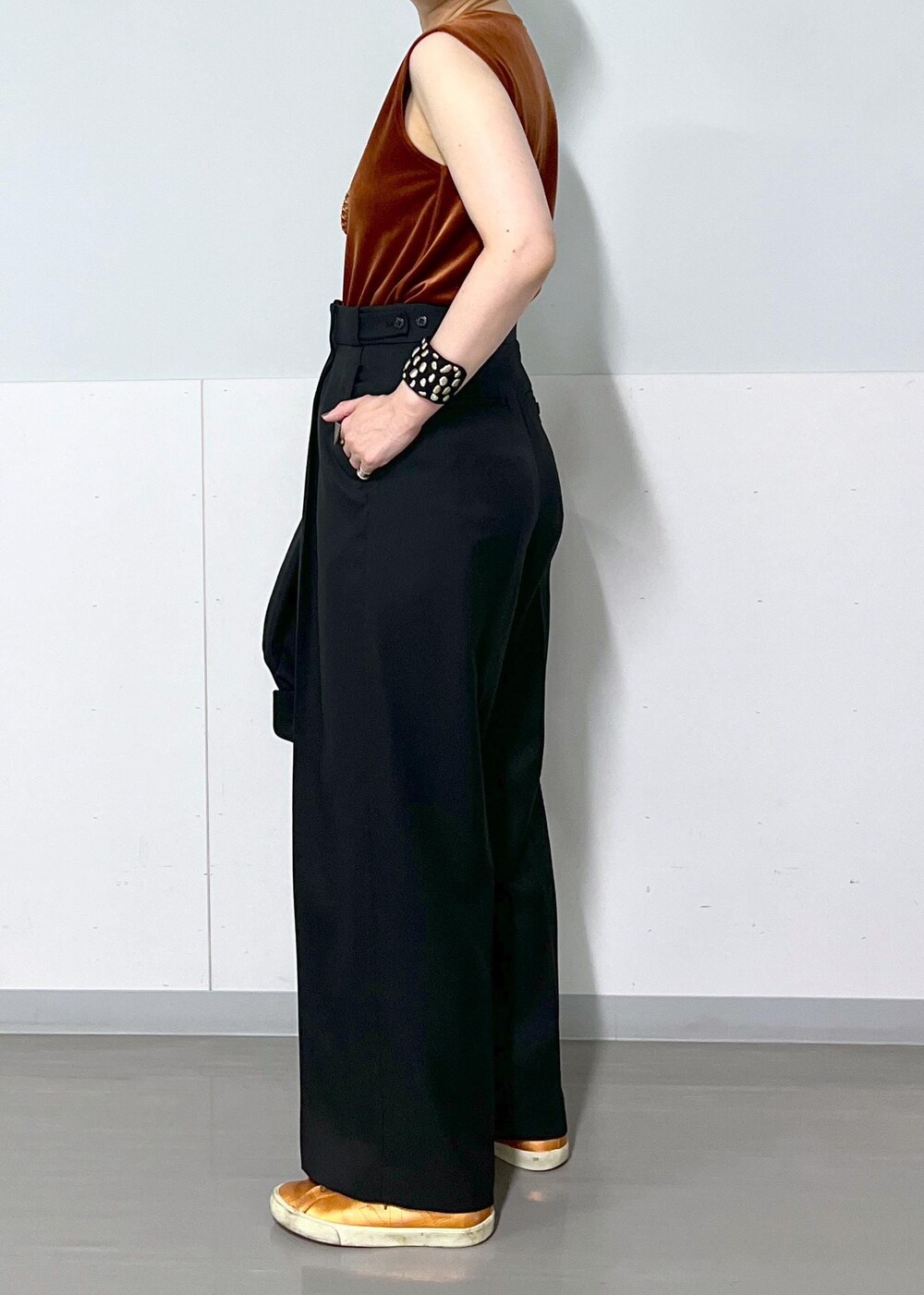 ブラック系のテーラードジャケット、ブラック系のスラックス、レッド系のTシャツ/カットソーを着用したレディースの秋コーディネートの7枚目の写真