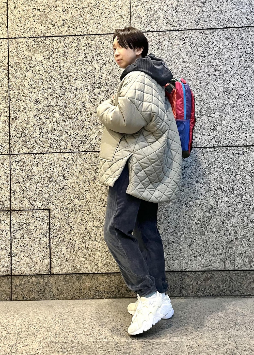 ブラック系のパーカー、ブラック系のその他パンツ、グリーン系のダウンジャケット/コートを着用したレディースの冬コーディネートの2枚目の写真