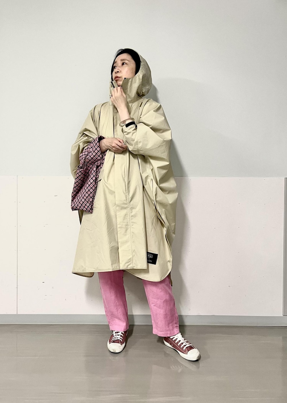 ピンク系のその他パンツ、ピンク系のトートバッグ、ベージュ系のレインコート/ポンチョを着用したレディースの春コーディネートの4枚目の写真