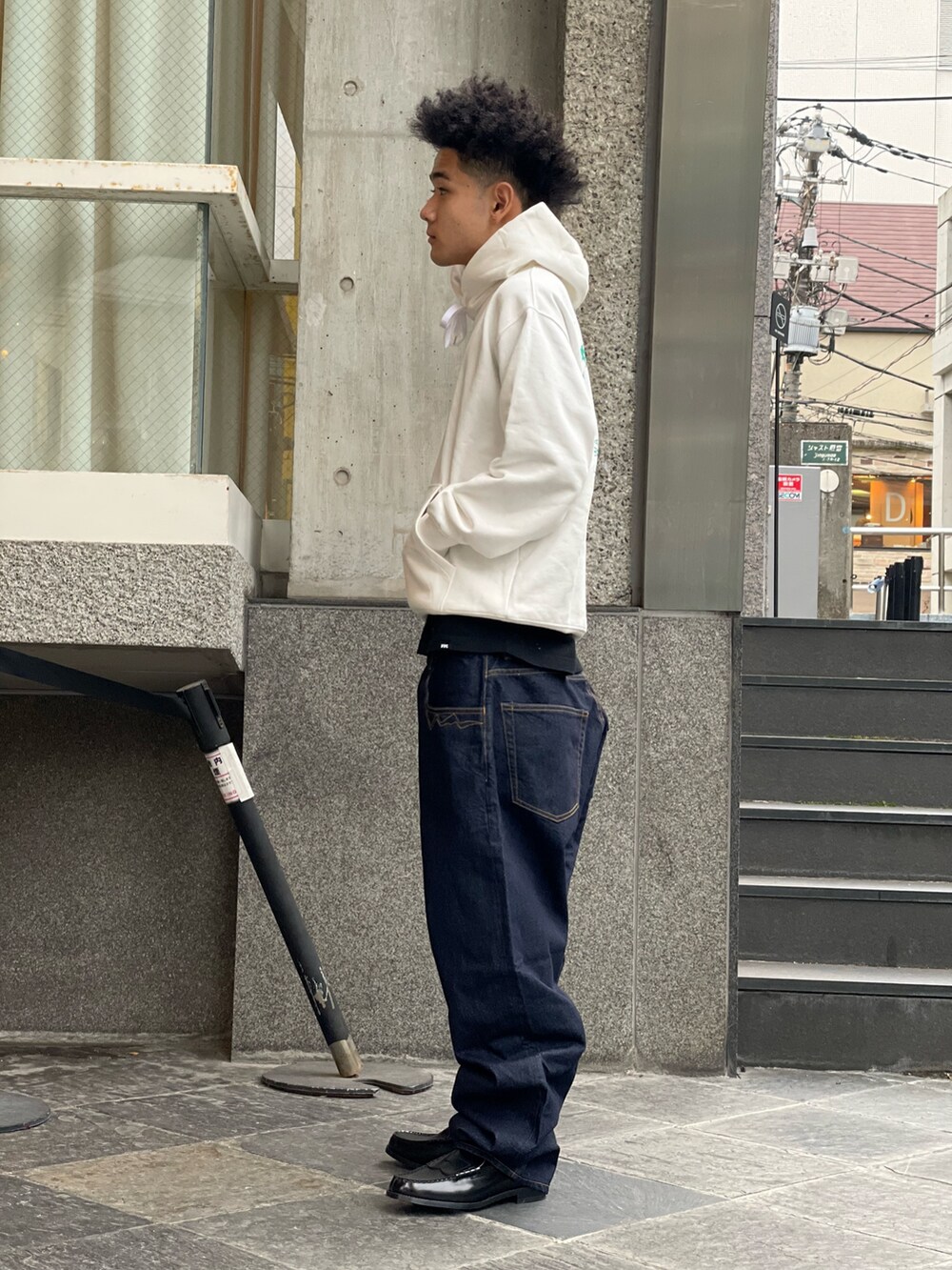 ホワイト系のパーカー、ブルー系のデニムパンツを着用したメンズの冬コーディネートの2枚目の写真