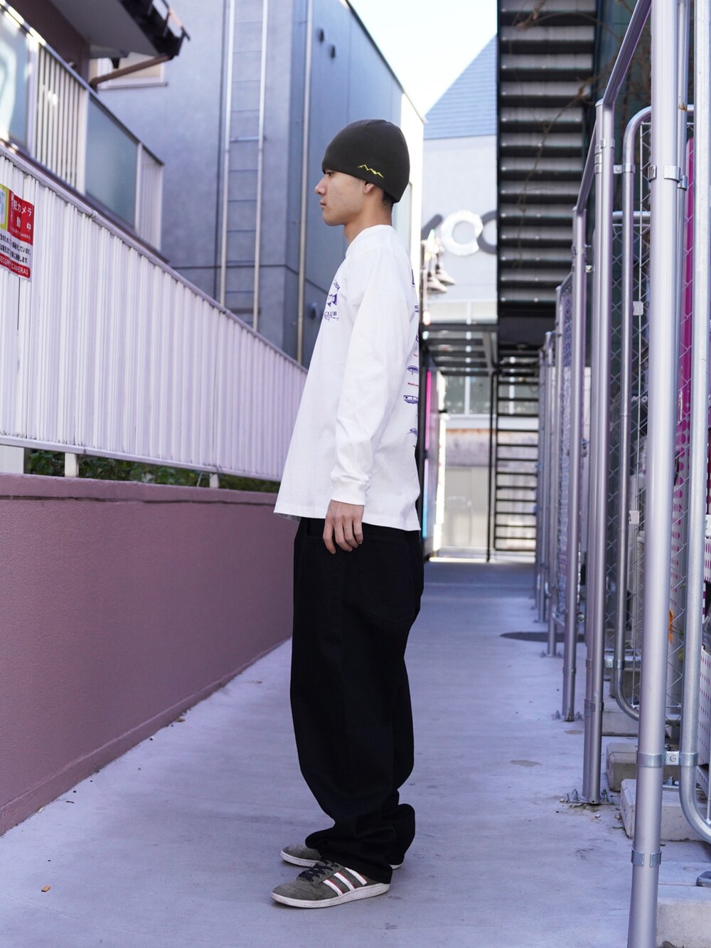 ホワイト系のTシャツ/カットソー、ブラック系のデニムパンツ、グリーン系のニットキャップ/ビーニーを着用したメンズの冬コーディネートの2枚目の写真