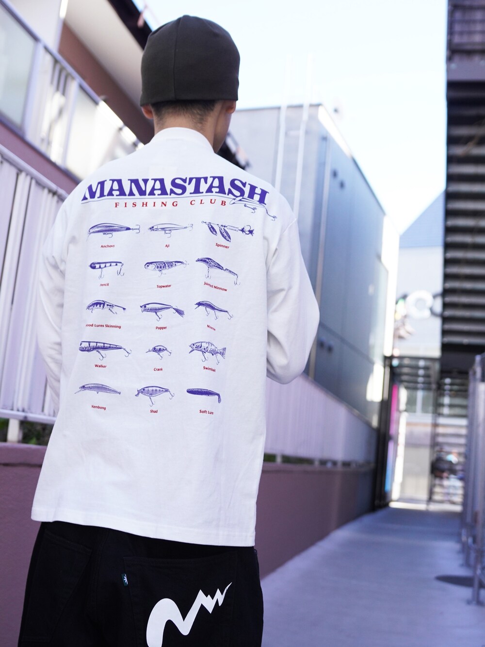 ホワイト系のTシャツ/カットソー、ブラック系のデニムパンツ、グリーン系のニットキャップ/ビーニーを着用したメンズの冬コーディネートの8枚目の写真