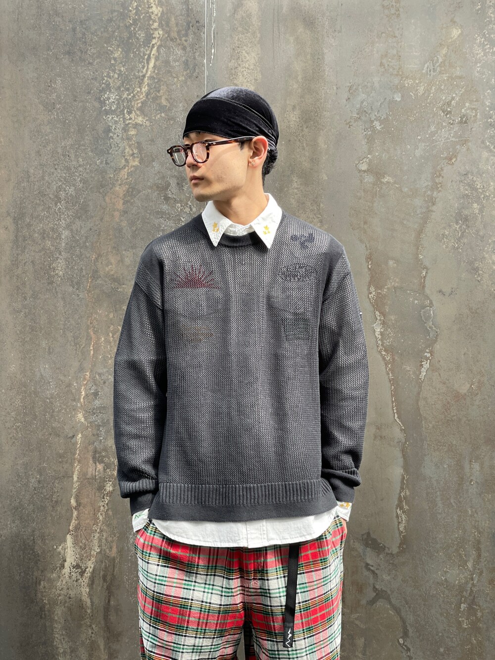 ブラック系のニット/セーター、レッド系のその他パンツ、ホワイト系のシャツ/ブラウスを着用したメンズの春コーディネートの4枚目の写真