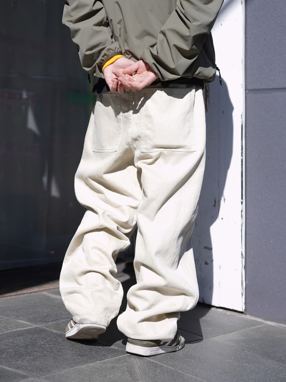 グリーン系のブルゾン、ベージュ系のその他パンツ、ホワイト系のハットを着用したメンズの冬コーディネートの10枚目の写真