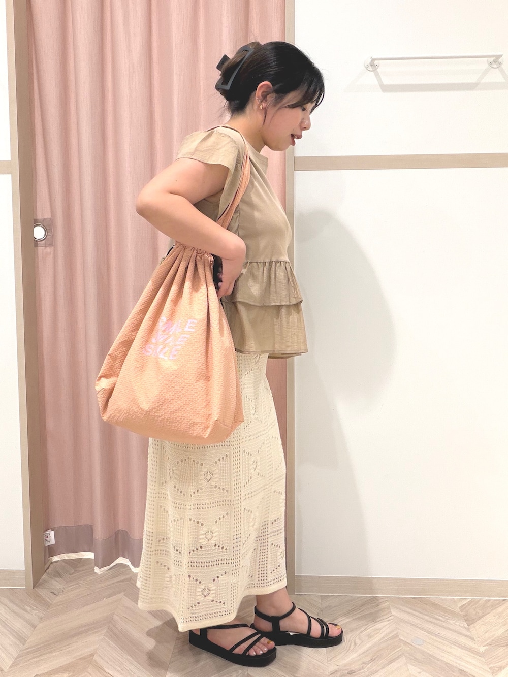 イエロー系のTシャツ/カットソー、ホワイト系のスカート、ブラック系のサンダルを着用したレディースの夏コーディネートの3枚目の写真