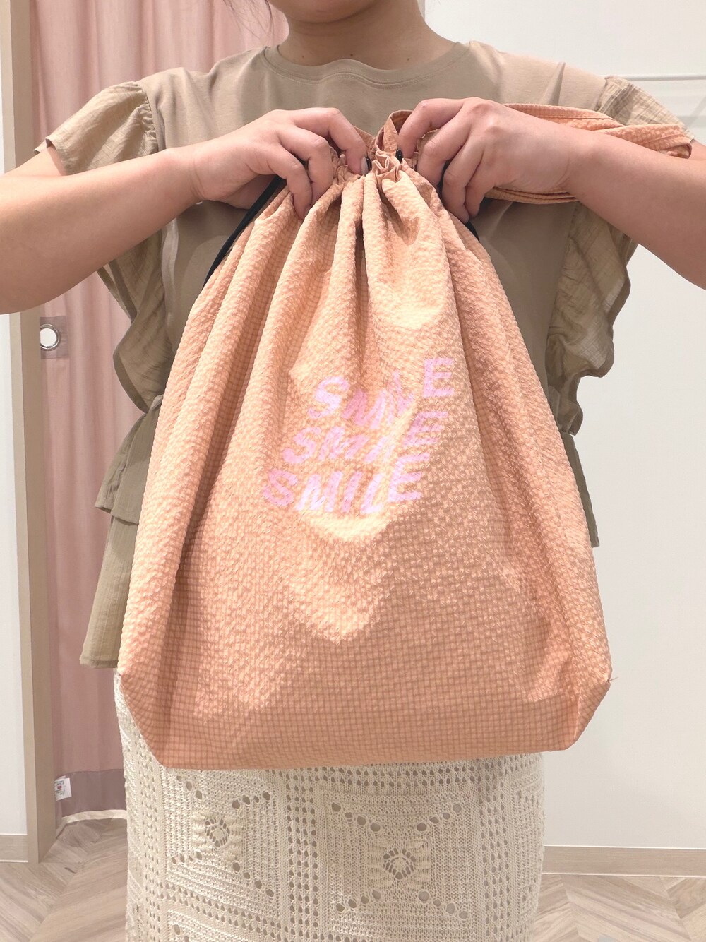 イエロー系のTシャツ/カットソー、ホワイト系のスカート、ブラック系のサンダルを着用したレディースの夏コーディネートの6枚目の写真