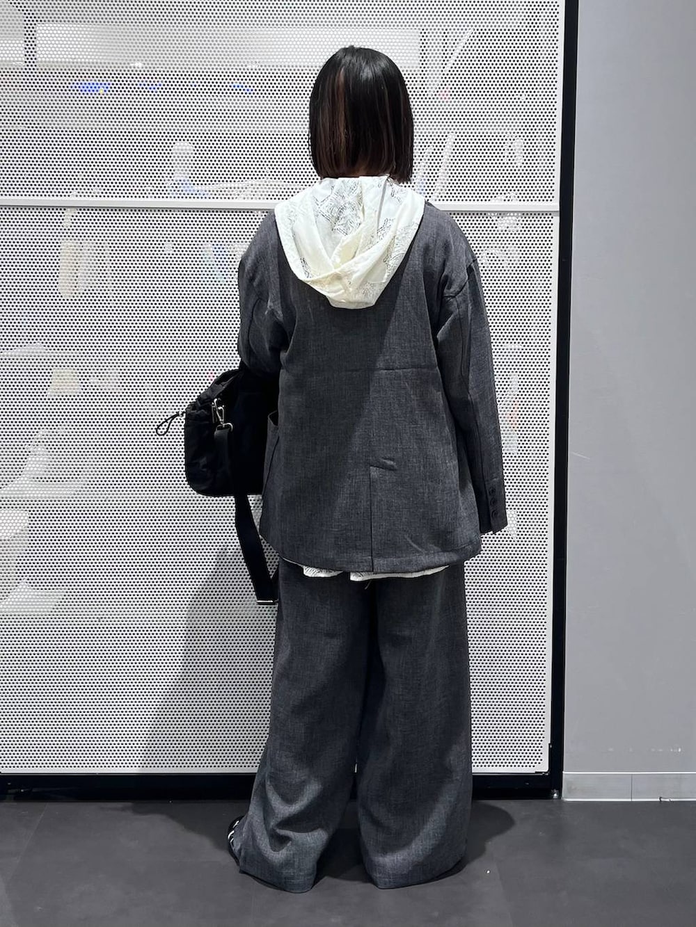 ブラック系のスニーカー、ブラック系のトートバッグ、ホワイト系のシャツ/ブラウスを着用したレディースの春コーディネートの5枚目の写真