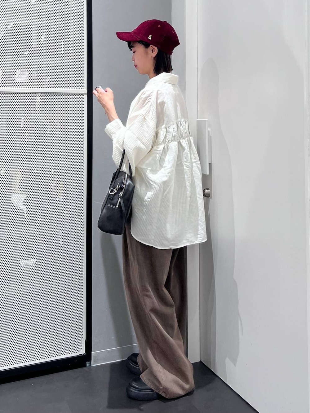 ベージュ系のシャツ/ブラウス、ブラウン系のデニムパンツ、ブラック系のその他シューズを着用したレディースの秋コーディネートの3枚目の写真