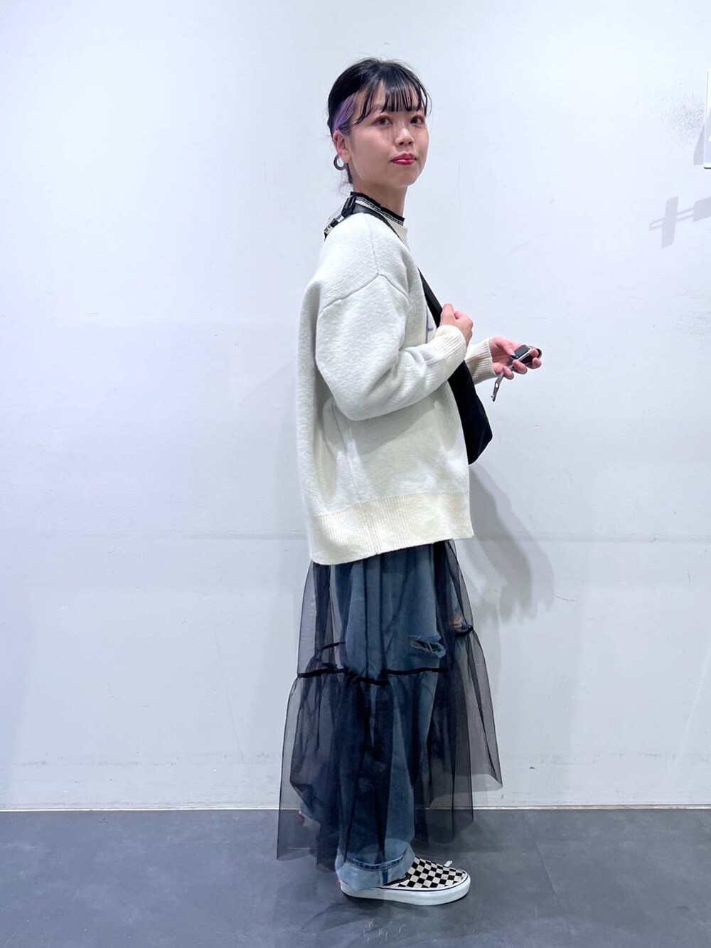 その他のニット/セーター、ブルー系のデニムパンツ、ブラック系のショルダーバッグを着用したレディースの冬コーディネートの3枚目の写真