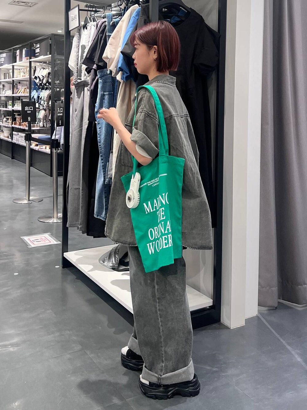 ブラック系のデニムパンツ、ブラック系のスニーカー、ブラック系のシャツ/ブラウスを着用したレディースの春コーディネートの4枚目の写真