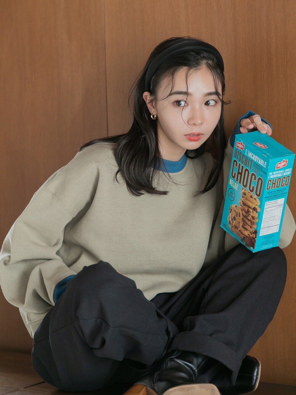 ブラック系のチノパンツ、ベージュ系のスウェットを着用したレディースの秋コーディネートの2枚目の写真