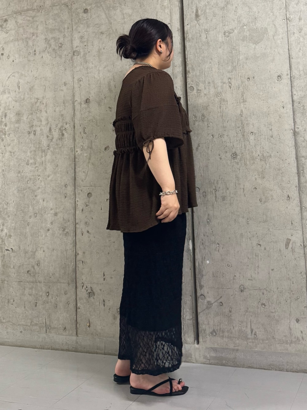 ブラウン系のシャツ/ブラウス、ブラック系のスカート、ブラック系のサンダルを着用したレディースの夏コーディネートの2枚目の写真