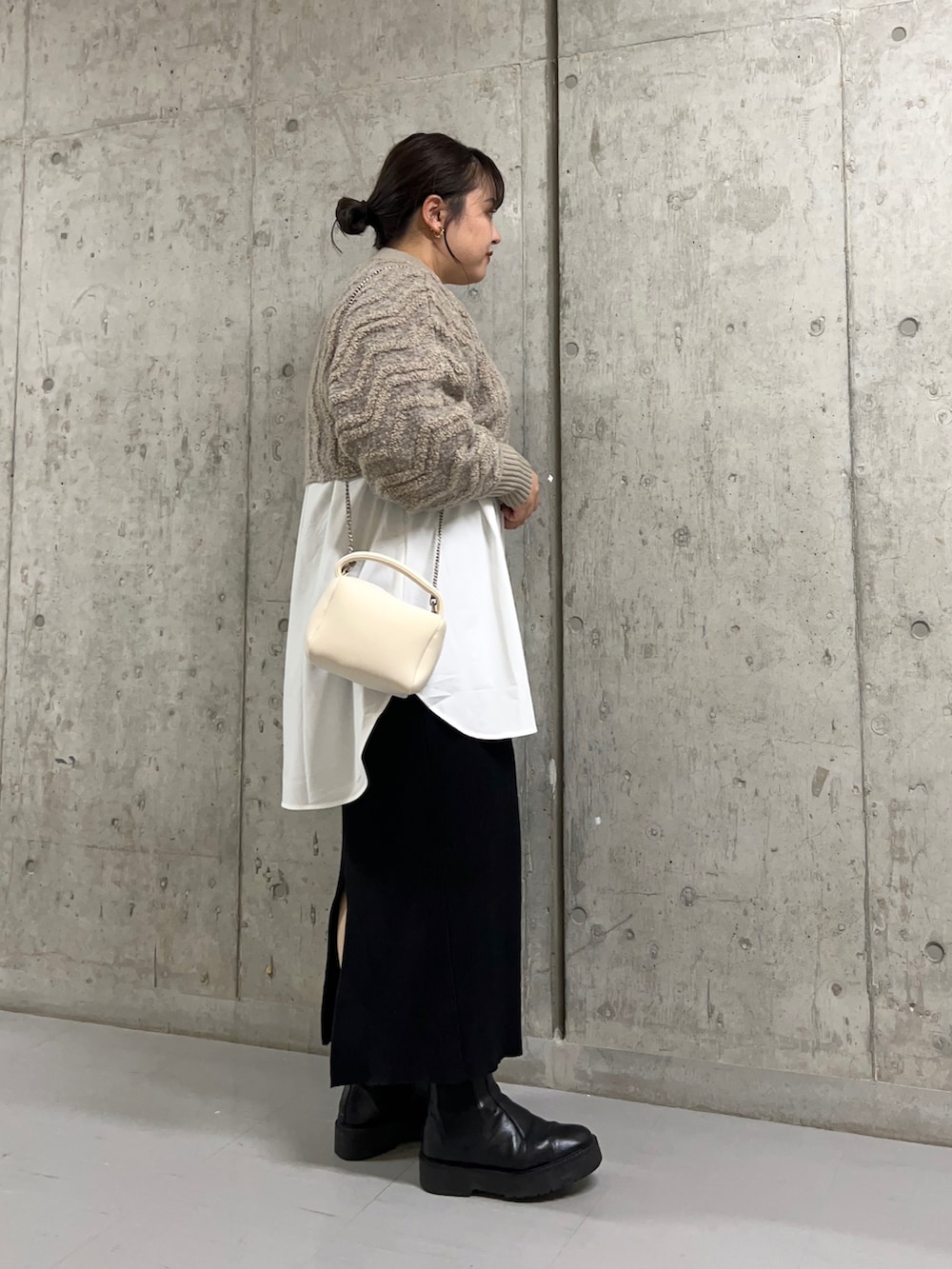 ホワイト系のハンドバッグ、ベージュ系のニット/セーター、ホワイト系のシャツ/ブラウスを着用したレディースの秋コーディネートの2枚目の写真
