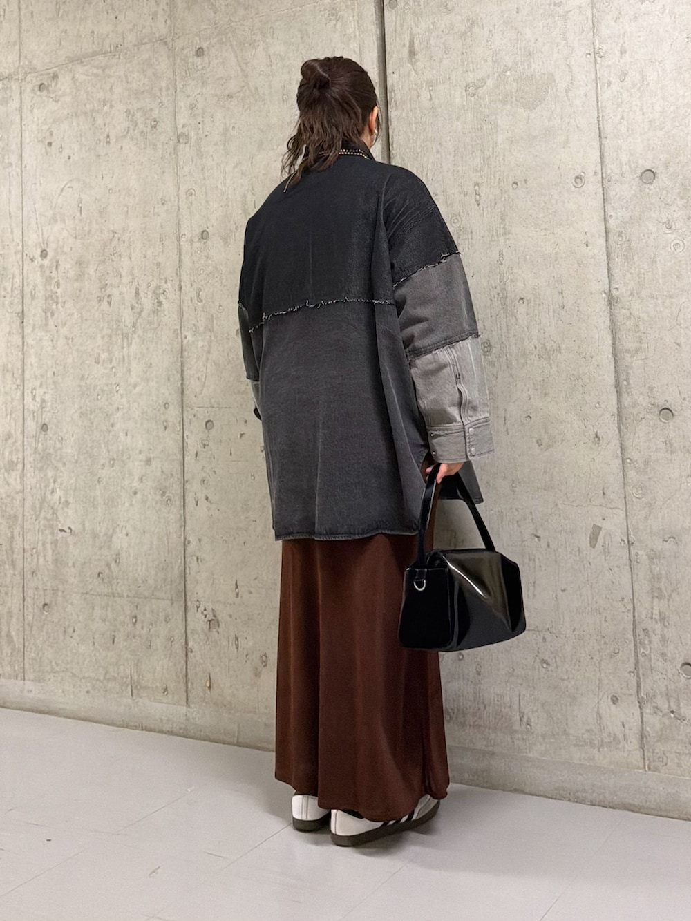 グレー系のシャツ/ブラウス、ブラウン系のスカート、ブラック系のトートバッグを着用したレディースの春コーディネートの3枚目の写真