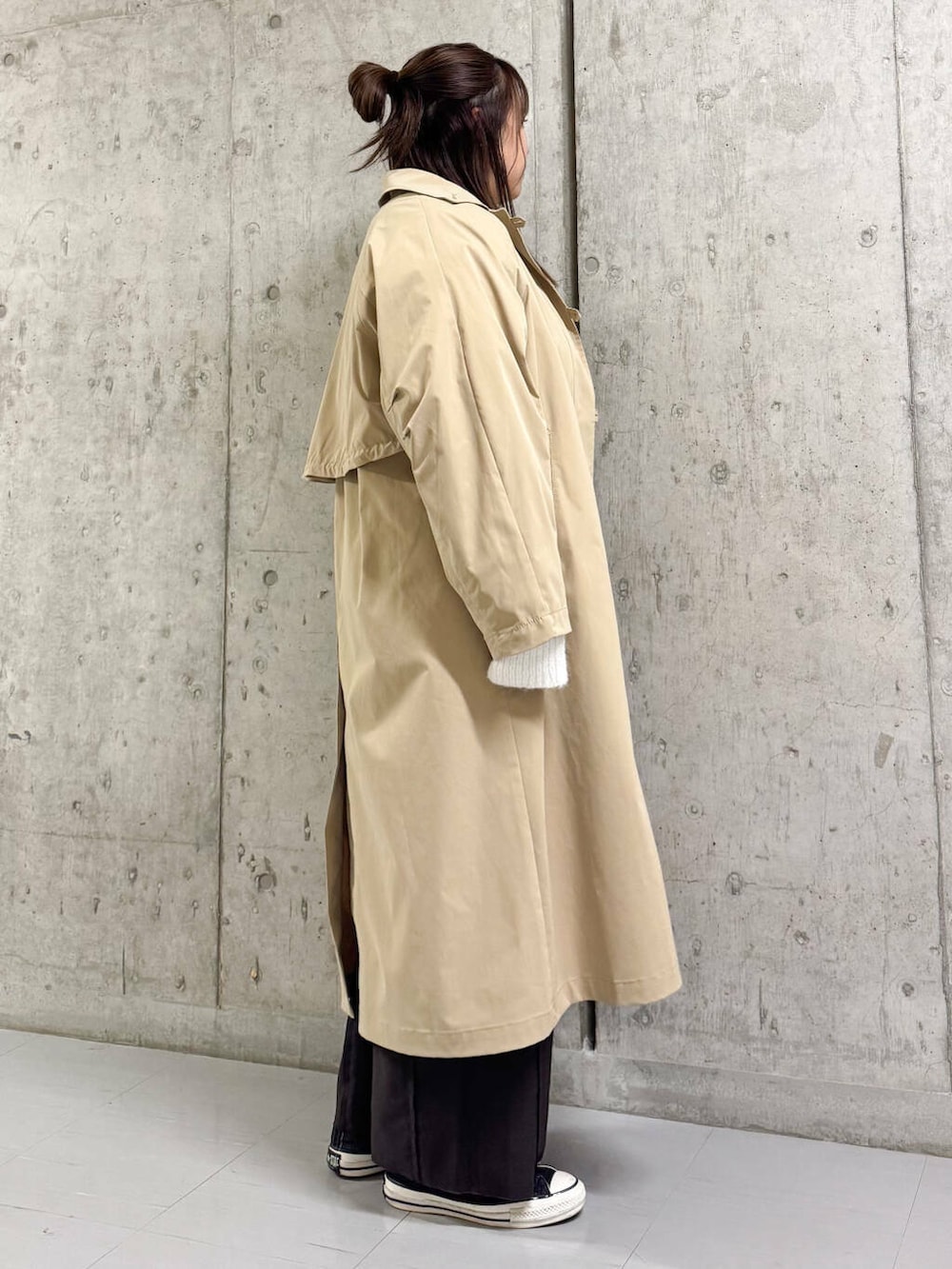 ホワイト系のニット/セーター、ブラウン系のその他パンツ、ベージュ系のステンカラーコートを着用したレディースの冬コーディネートの3枚目の写真