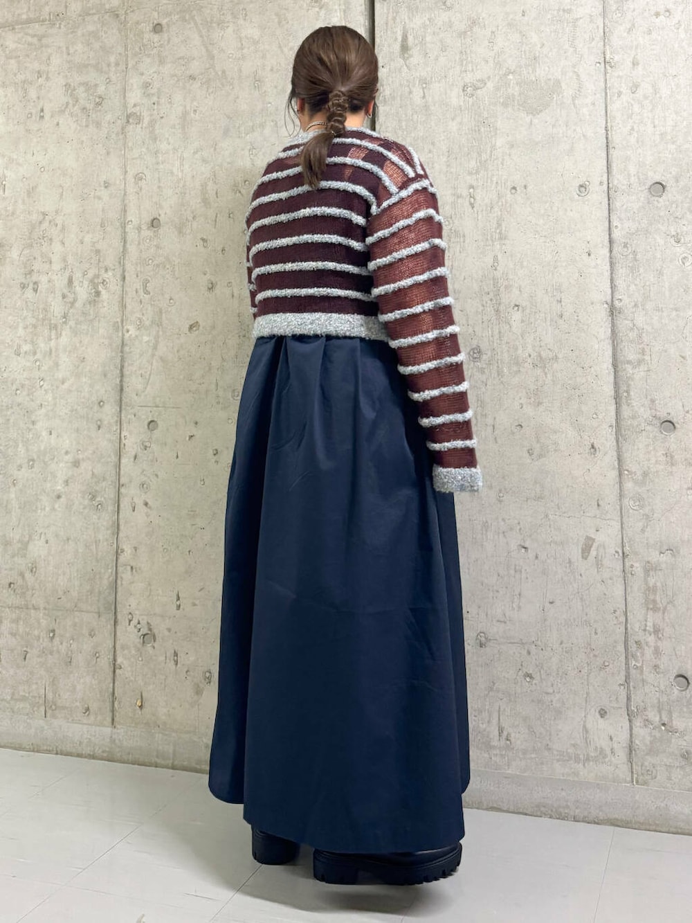 ブラック系のブーツ、ブルー系のワンピース、ブルー系のニット/セーターを着用したレディースの秋コーディネートの3枚目の写真